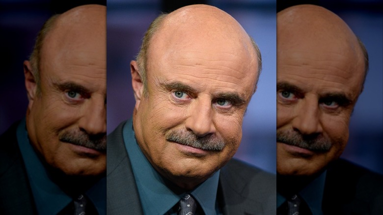 A close-up of Dr. Phil staring off to the left