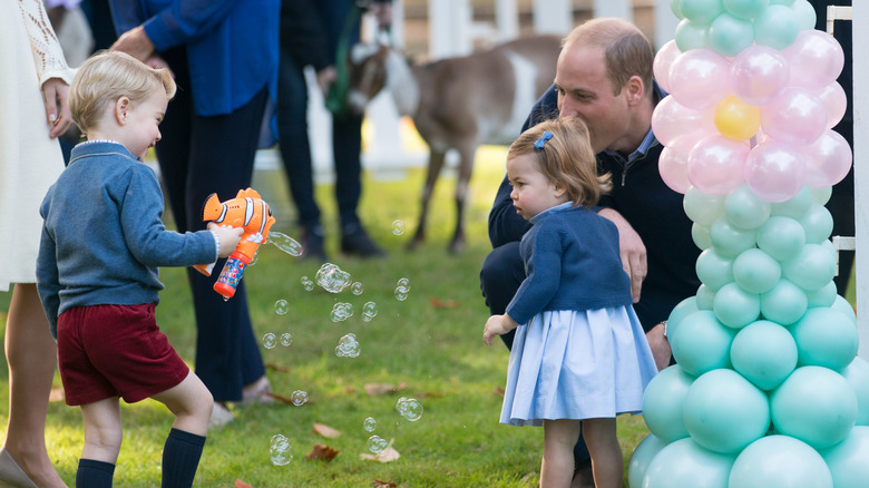 Prince George points bubbles at Princess Charlotte