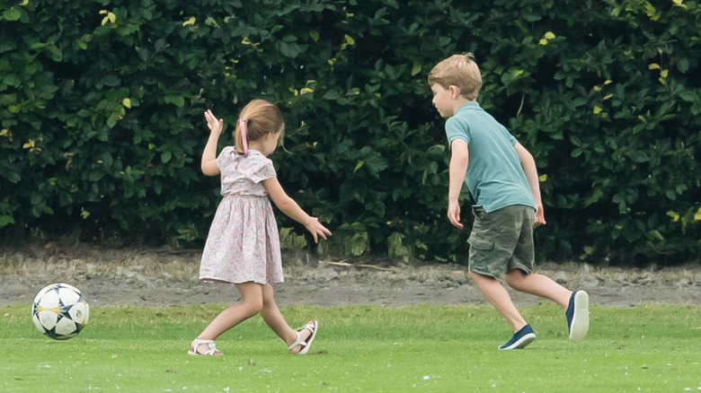 Princess Charlotte and Prince George kick a soccer ball together