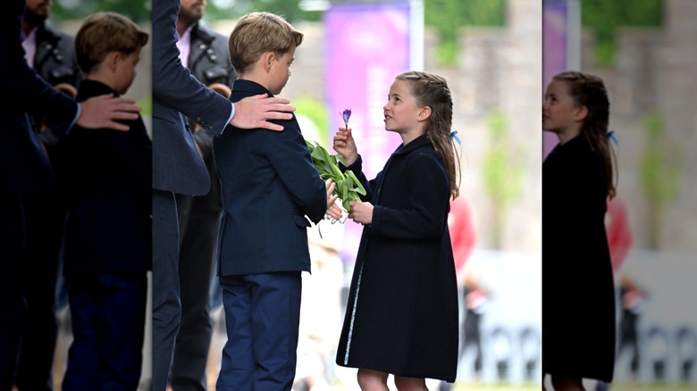 Princess Charlotte gives a flower to Prince George.
