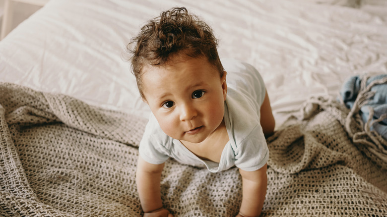 A baby boy looking up