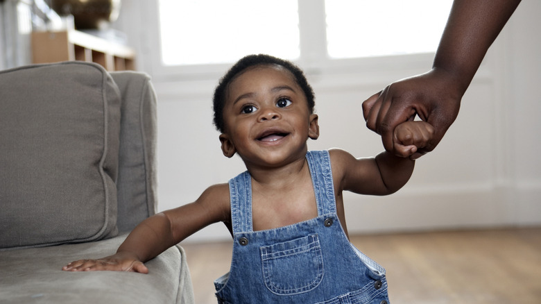 A baby boy in overalls