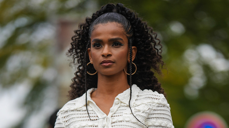 Model with curly ponytail