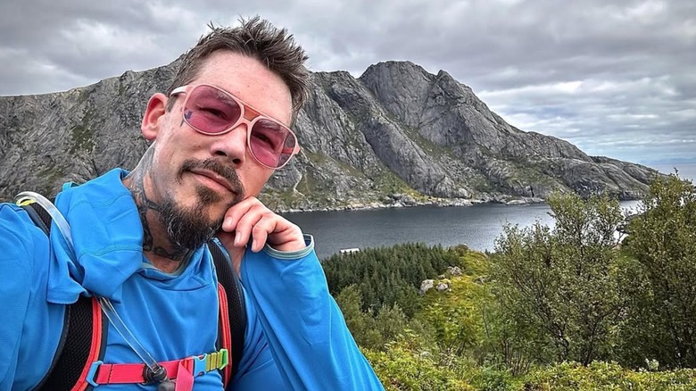 David Bromstad posing on a mountain