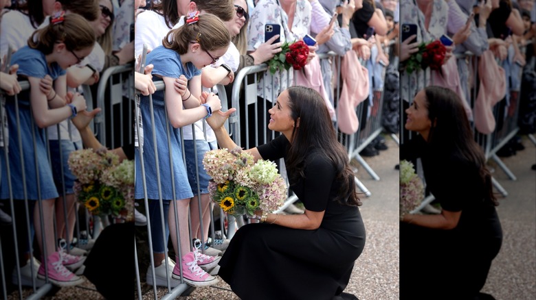 Meghan Markle holding flowers and speaking to a young girl on September 10, 2022