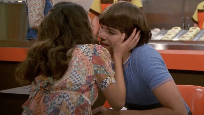Mila Kunis and Ashton Kutcher going in for a kiss on "That '70s Show"