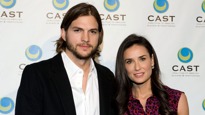 Ashton Kutcher and Demi Moore posing on step-and-repeat