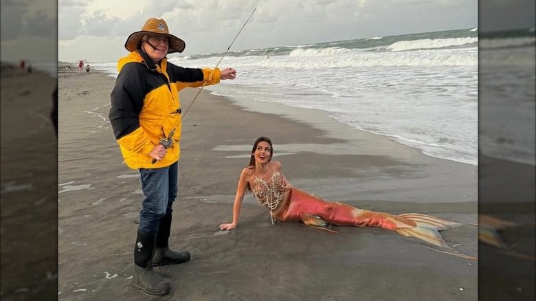 Bill Belichick and Jordon Hudson wearing fisherman and mermaid costumes