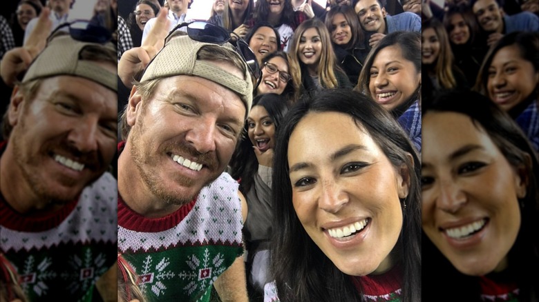 Chip and Joanna Gaines posing in front of large group of people