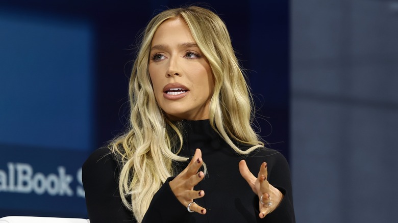 Alex Cooper speaking onstage in New York in 2024