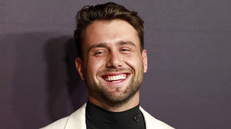 Harry Jowsey smiling on the red carpet in 2026