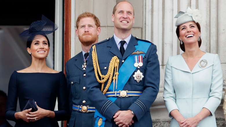 Meghan Markle, Prince Harry, Prince William, and Princess Catherine on Buckingham Palace balcony looking up