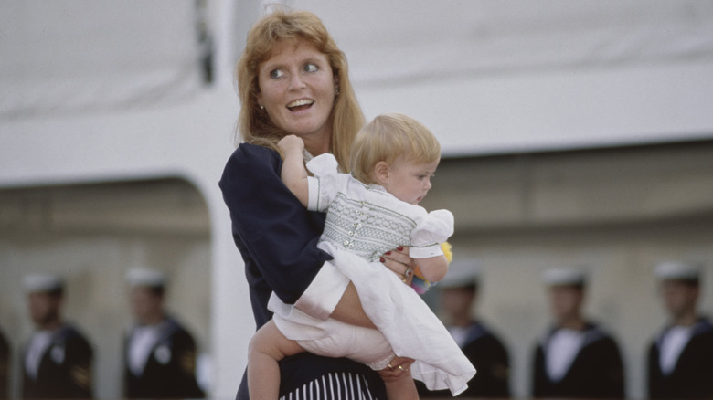 Sarah Ferguson holding a baby Princess Beatrice in her arms