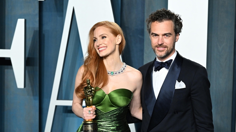 Jessica Chastain in green dress beside Gian Luca Passi de Preposulo at the Oscars