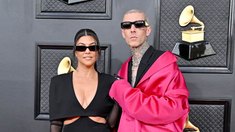 Travis Barker in pink jacket with Kourtney Kardashian at the Grammys