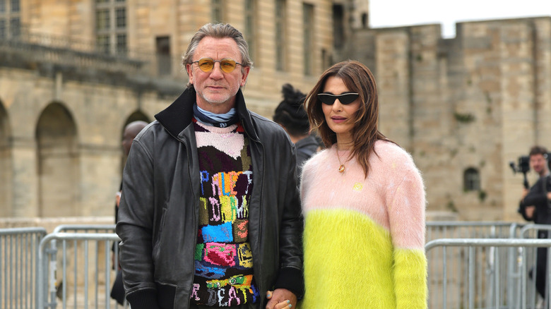 Rachel Weisz in a neon sweater beside Daniel Craig