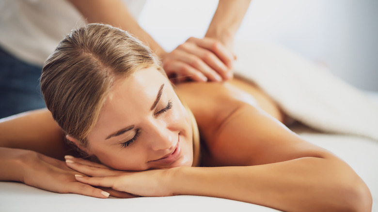 woman on her stomach getting a massage