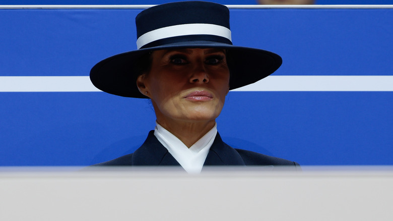 Melania Trump looking wide-eyed beneath a big hat