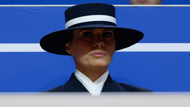 Melania Trump looking wide-eyed beneath a big hat