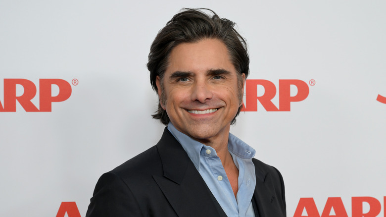 John Stamos posing at an event