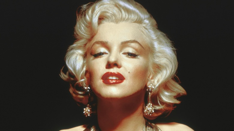 A closeup of Marilyn Monroe on a black background