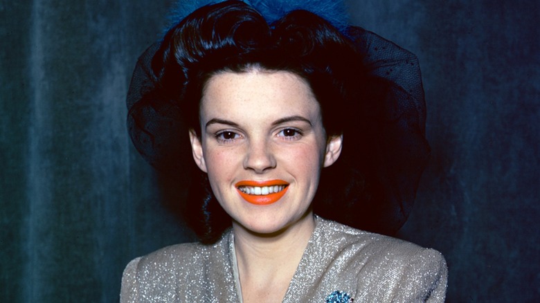 A young Judy Garland with a strained smile