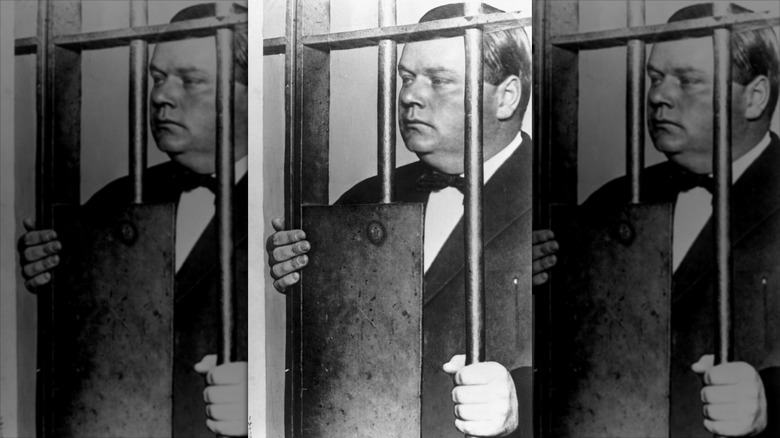 Fatty Arbuckle holding onto jail cell bars