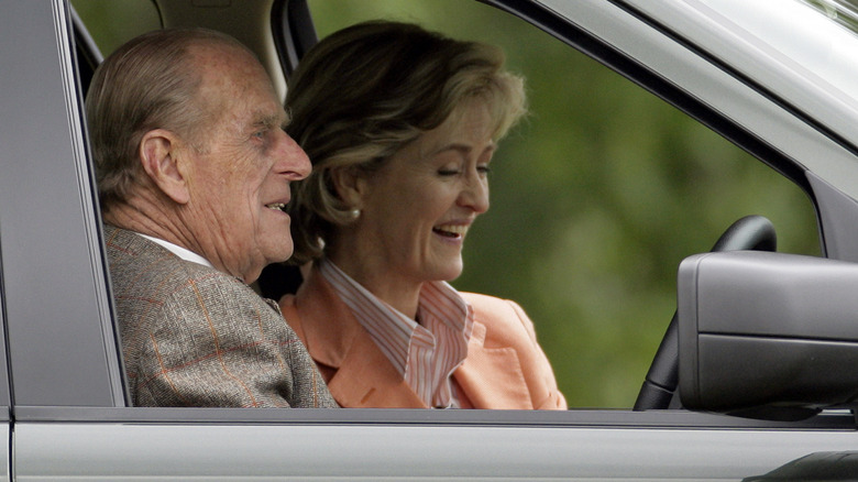 Prince Philip chatting in a parked car with Penny Romsey