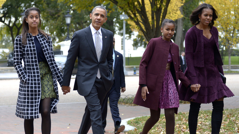 The Obama family walking hand-in-hand outside