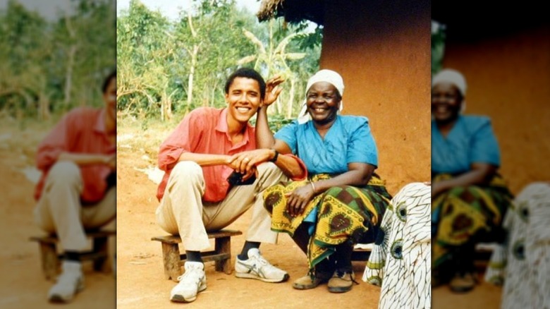 Barack Obama smiling with his grandmother Sarah Ogwel Onyango Obama outside her home in Kenya