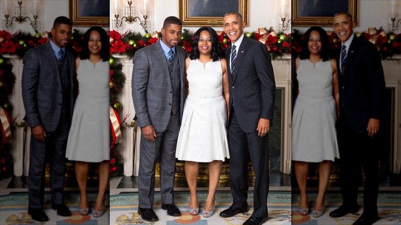 Tafari Campbell, Sherise Campbell, and Barack Obama posing at a fireplace covered with Christmas decorations