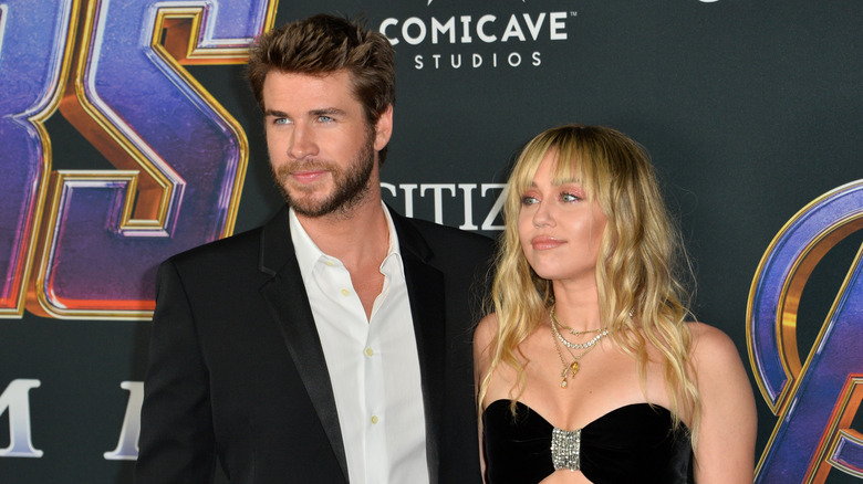 Liam Hemsworth and Miley Cyrus twinning in black at film premiere