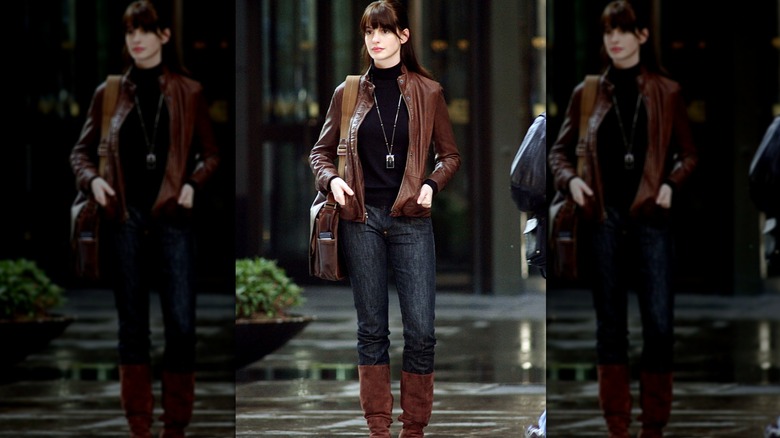 Anne Hathaway as Andy Sachs wearing a black turtleneck, jeans, and a brown leather jacket in "The Devil Wears Prada."