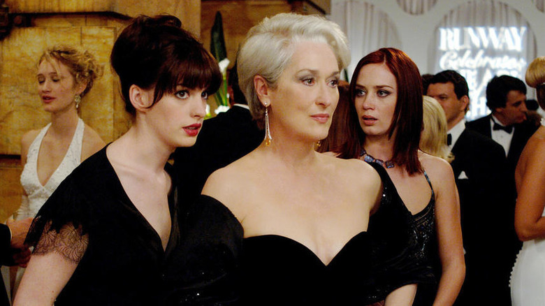 Anne Hathaway, Meryl Streep, and Emily Blunt wearing black gowns as their characters in "The Devil Wears Prada."