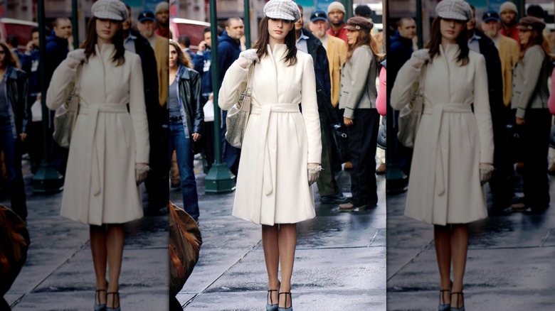 Anne Hathaway as Andy Sachs walking down the streets of New York in a white coat and matching cap in "The Devil Wears Prada."
