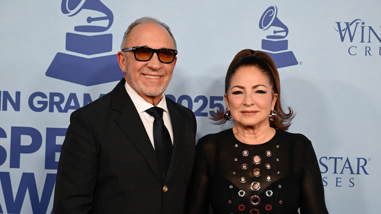 Emilio Estefan smiling with Gloria Estefan in black formals.