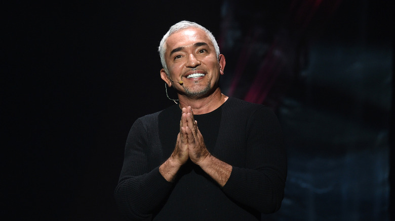 Cesar Millan onstage in front of a black background