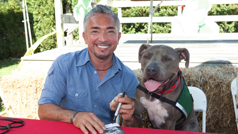 Cesar Millan posing with his pit bull, Junior
