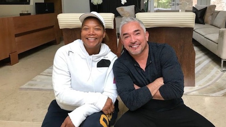 Queen Latifah posing with Cesar Millan