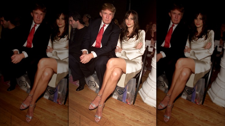 Melania and Donald Trump sitting together at the Marc Bouwer Fall 2002 fashion show in New York.
