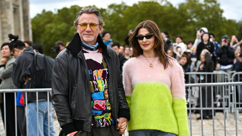 Rachel Weisz in a neon sweater beside Daniel Craig