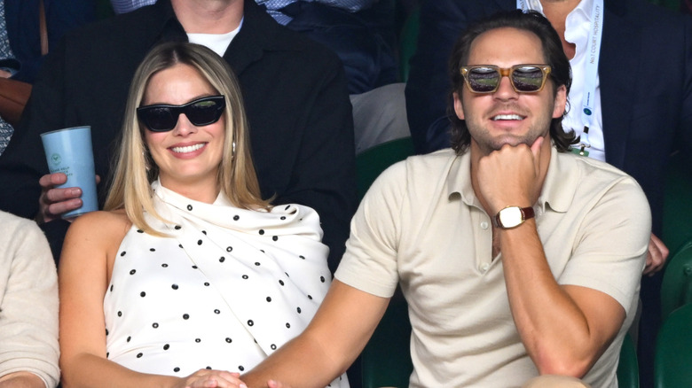 Margot Robbie and Tom Ackerley watching the Wimbledon matches