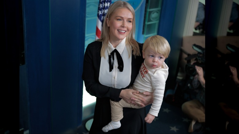 Karoline Leavitt holding her child at the turkey pardoning