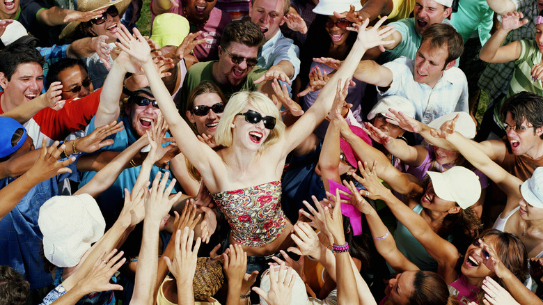 Woman standing in crowd of fans