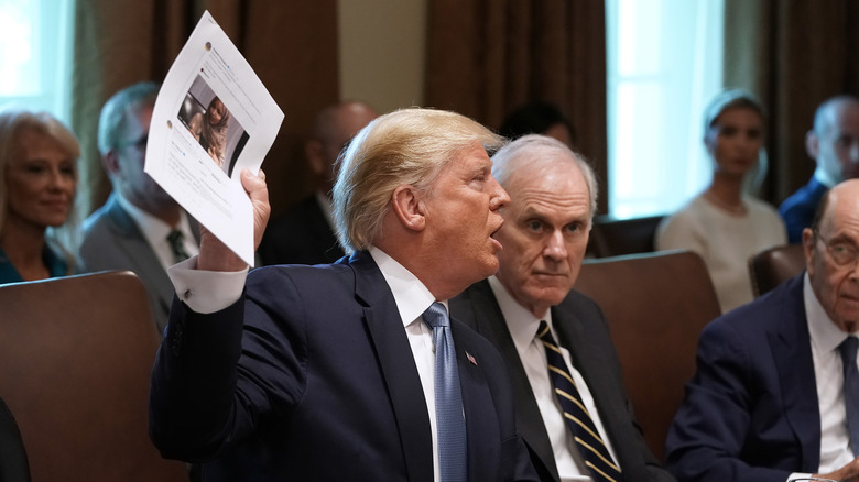 Donald Trump holding up a photo of representative Ilhan Omar in July 2019