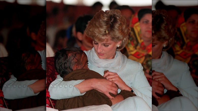 Princess Diana holding a child