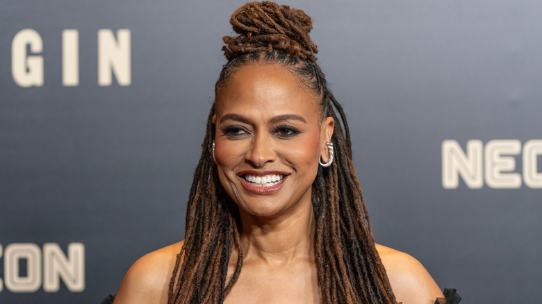 Ava DuVernay smiling with a topknot hairstyle