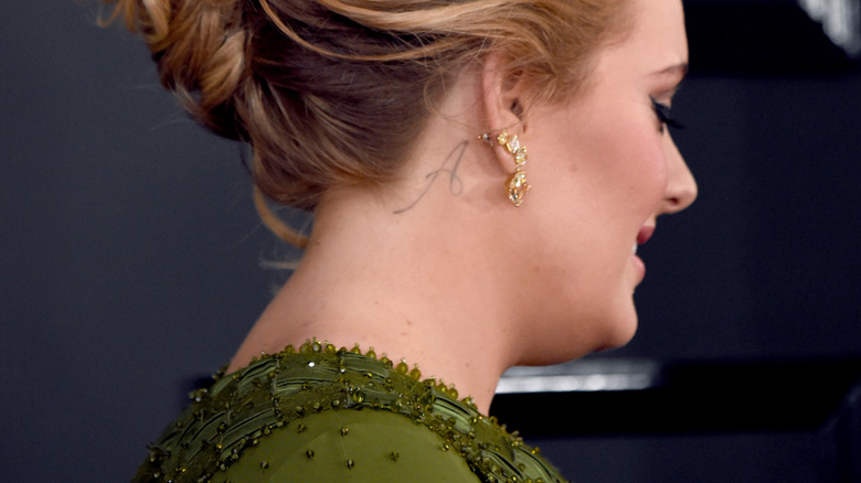 Adele's neck tattoo of an "A"