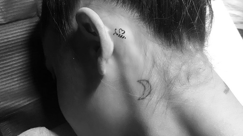 Ariana Grande's neck tattoo of a crescent moon