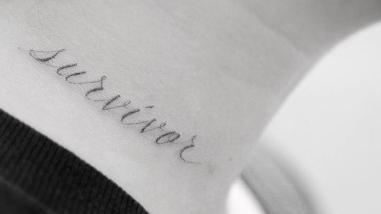 Demi Lovato's neck tattoo reads "survivor"